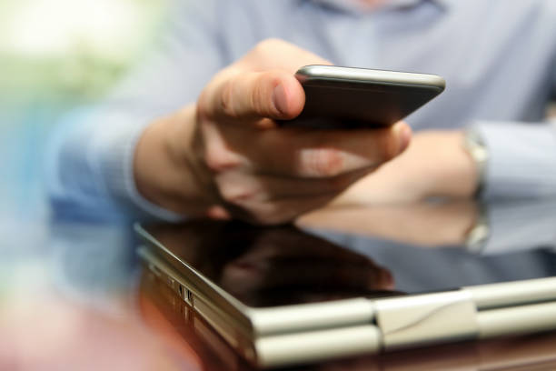 istock Business man working and analyzing financial figures on a graphs using laptop and mobile phone 670258754