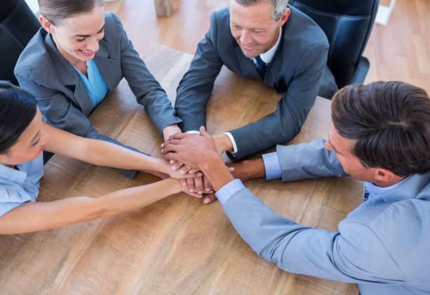 istock Business people joining hands in a circle 670262268