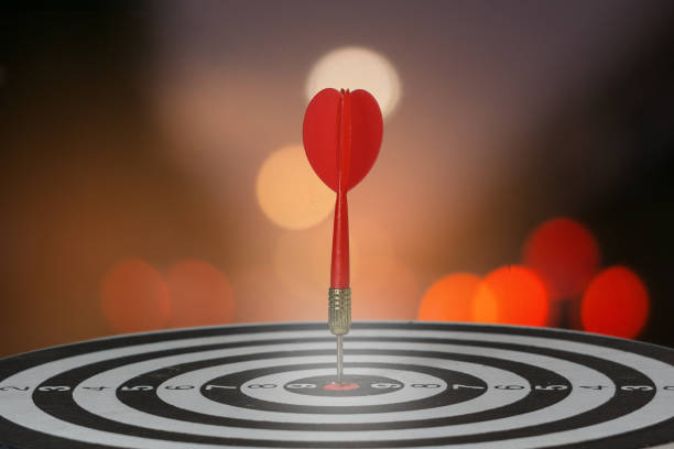 istock target dart with arrow over blurred bokeh background ,metaphor to target marketing or target arrow concept. 670263798