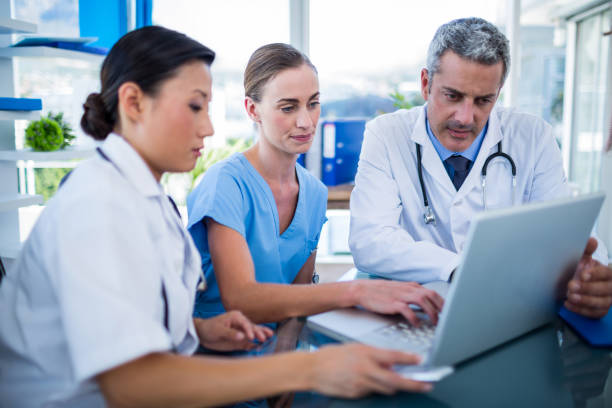 istock Doctors and nurse looking at laptop 670264804