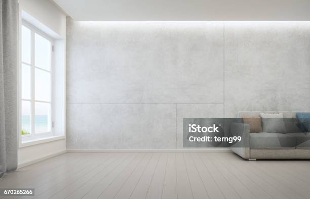 Sea View Living Room With Wooden Floor And Concrete Wall Background In Modern Beach House White Interior Of Vacation Home Stock Photo - Download Image Now