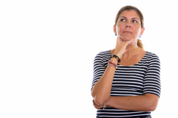 Studio shot of mature beautiful woman thinking while looking up horizontal shot