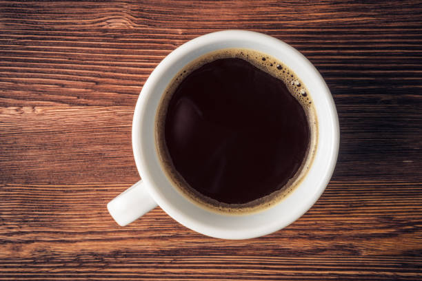 istock Coffee cup over old wooden background 670266814
