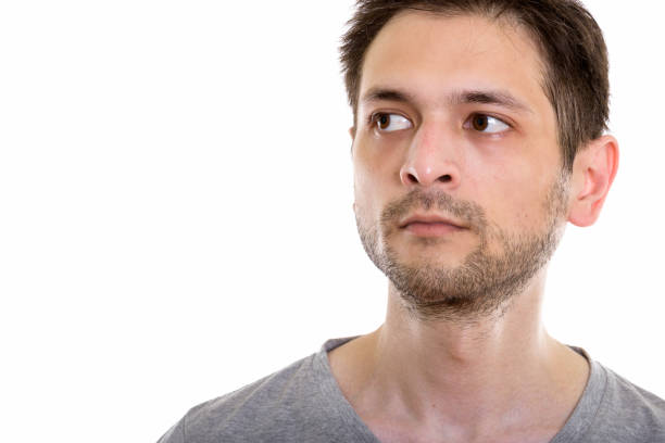 istock Close up of young man thinking while looking at distance 670271402