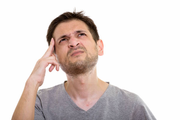 istock Studio shot of stressed young man thinking and looking up 670271648