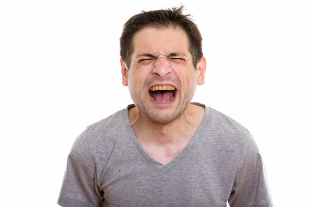 istock Studio shot of angry young man screaming with eyes closed 670271738