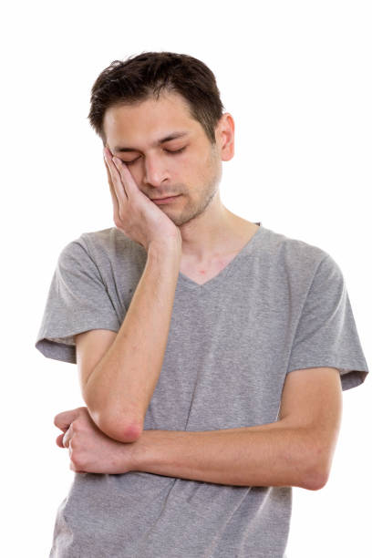 istock Studio shot of tired young man sleeping while resting face on hand 670271776