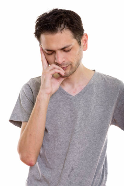 istock Studio shot of stressed young man having headache with eyes closed 670271782