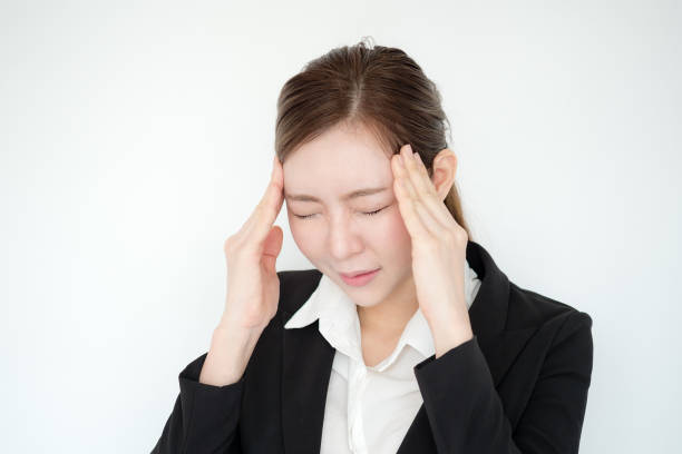 istock Young asian business woman headache. 670273590
