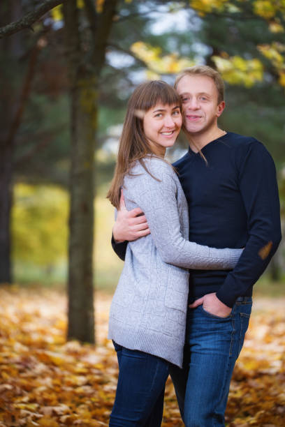 istock Young happy couple posing in autumn park 670274788