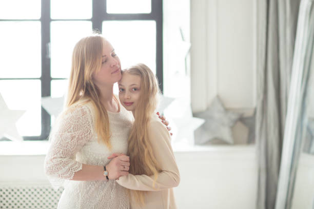 istock Beautiful mom and daughter light style and hugs 670275698