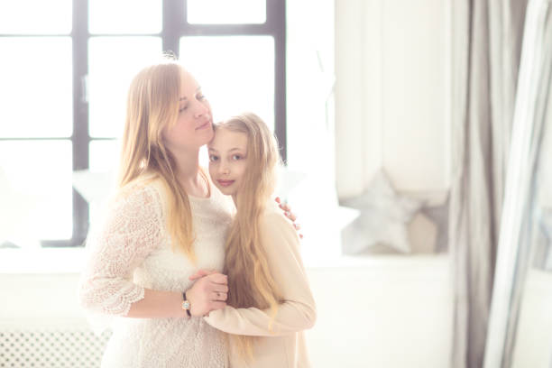 istock Beautiful mom and daughter light style and hugs 670275702