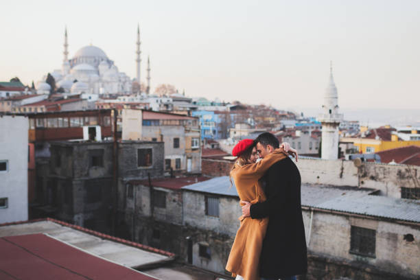 couple in love on roof in old city istanbul. beautiful mosque view on background - sexual issues sexual activity couple tan imagens e fotografias de stock