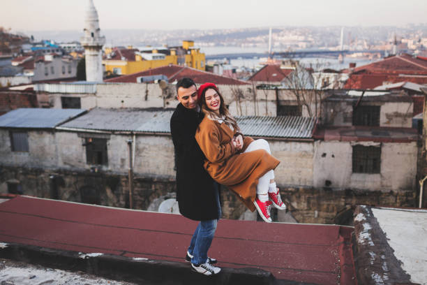 funny stylish couple having fun on roof. red beret and beige coat - sexual issues sexual activity couple tan imagens e fotografias de stock