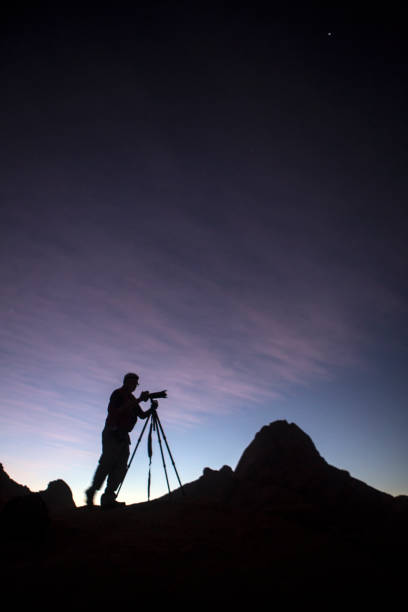 istock Photographer taking photo's at dusk. 670281040