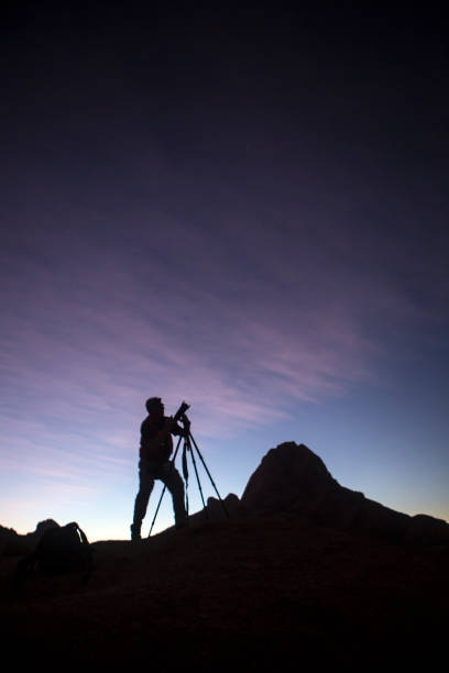 istock Photographer taking photo's at dusk. 670291746