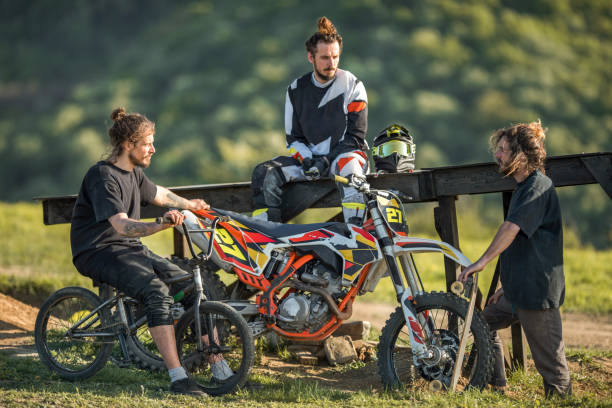 istock Three young extreme sportsmen relaxing in nature and talking. 670292084