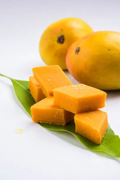 Photo of Indian sweet - traditional mango burfi or cake or bar made up of authentic alphonso or hapus mangos from konkan, india