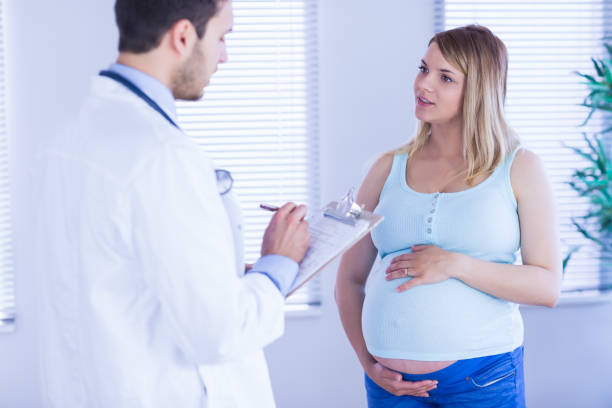 istock Pregnant patient talking to doctor which is taking notes 670314198