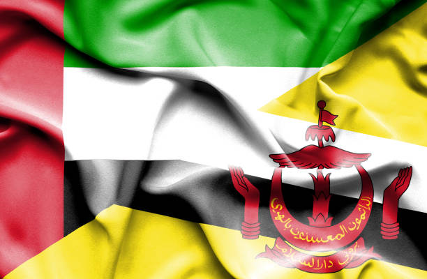 mengibarkan bendera brunei dan uni emirat arab - brunei money ilustrasi stok