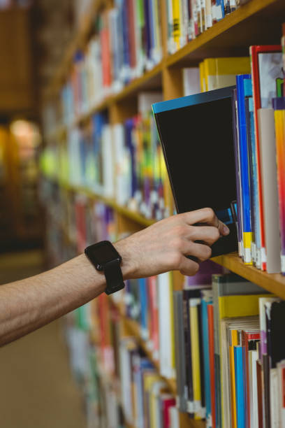 istock Student wearing a smart watch in library 670315052