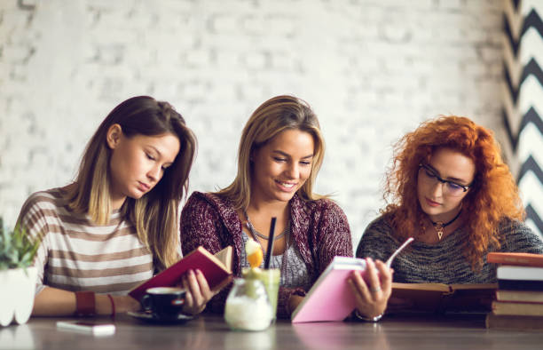 istock Young women studying and reading books at home. 670321056