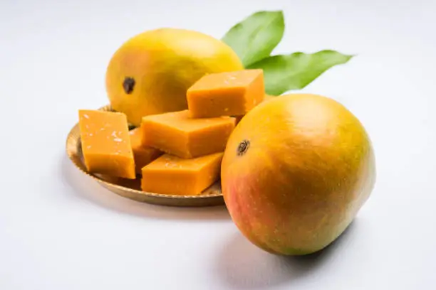 Photo of Indian sweet - traditional mango burfi or cake or bar made up of authentic alphonso or hapus mangos from konkan, india