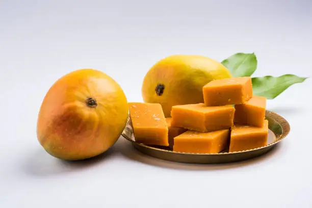 Photo of Indian sweet - traditional mango burfi or cake or bar made up of authentic alphonso or hapus mangos from konkan, india