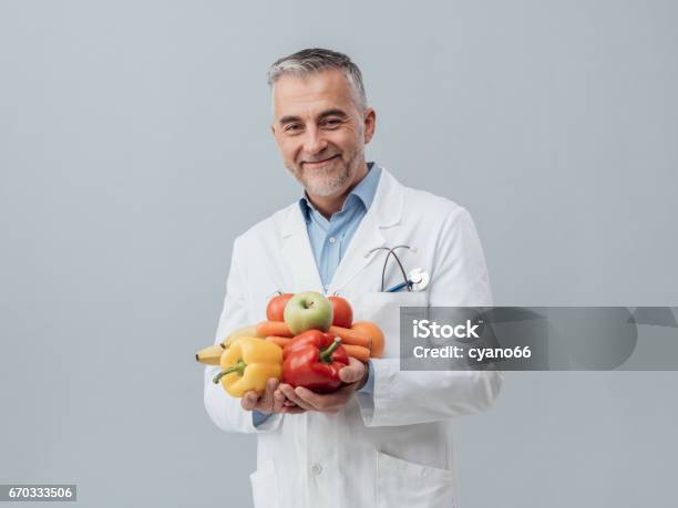 Smiling Nutritionist Holding Fresh Vegetables And Fruit Stock Photo - Download Image Now