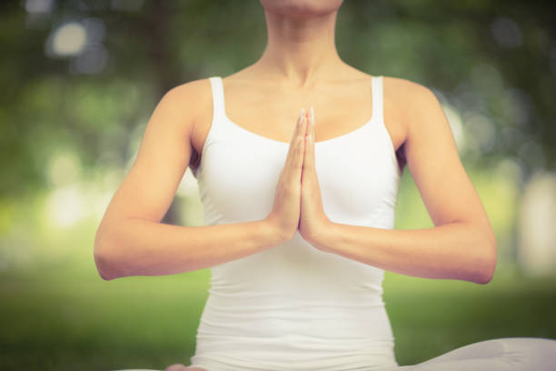 istock Mid section of woman with hands clasped 670338342