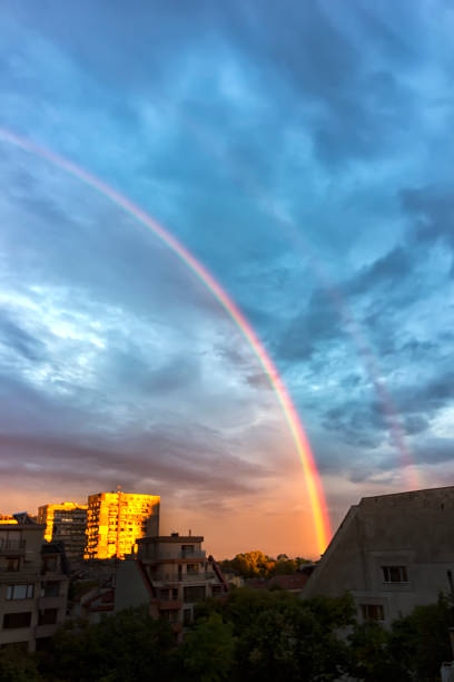 istock Bright colorful rainbow over city 670338674