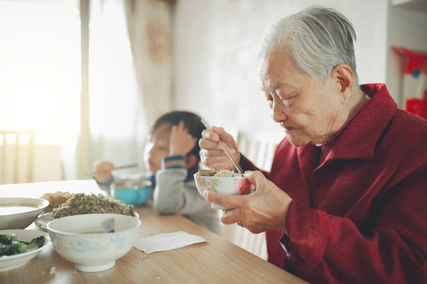 istock Happy Asian family enjoying lunc 670341338