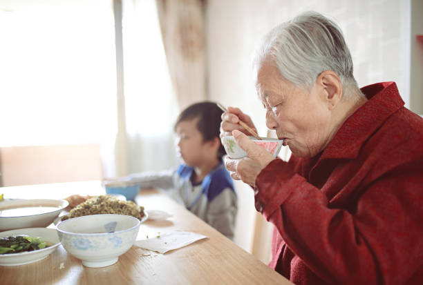 istock Happy Asian family enjoying lunc 670341580