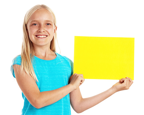 A pretty little blonde girl holds up a blank yellow placard - ready for your message - smiling proudly.
