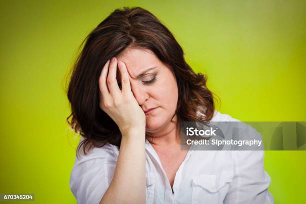Portrait Unhappy Middle Age Woman Head On Hand Bothered By Mistake Stock Photo - Download Image Now