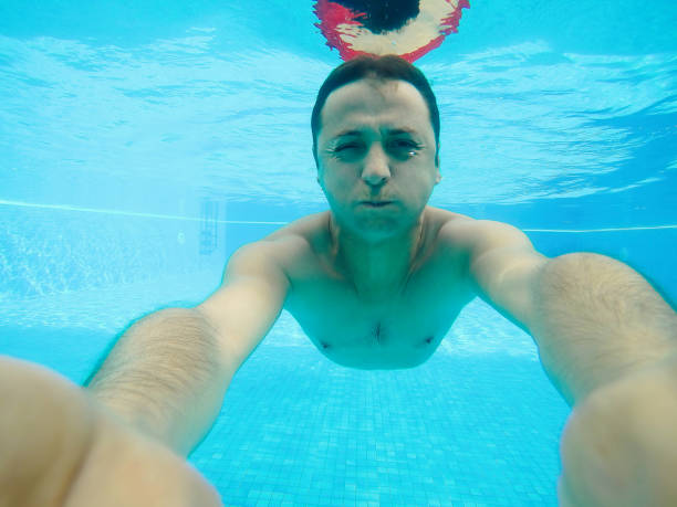 istock Young man self portrait underwater swimming pool 670345404