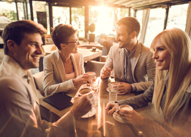 istock Young business team relaxing on coffee break in a cafe. 670346602