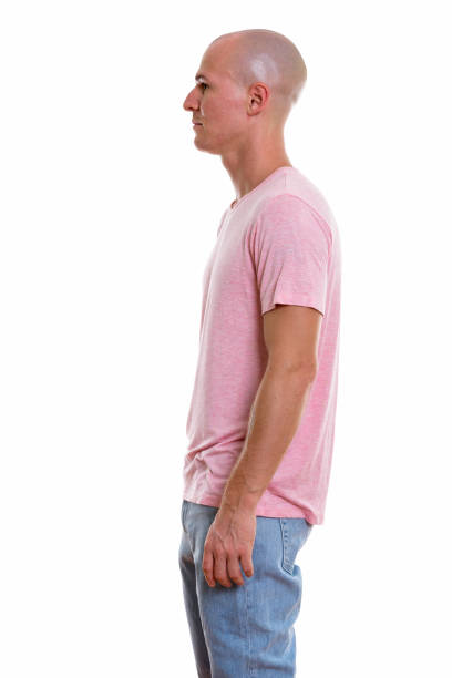 istock Profile view of young handsome bald man standing 670352858