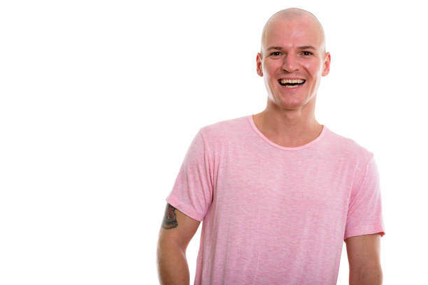 Studio shot of young happy bald man smiling horizontal shot