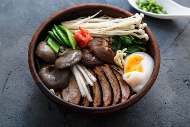 istock Ramen noodles bowl with egg, enoki, shiitake mushrooms, duck and onion 670354030