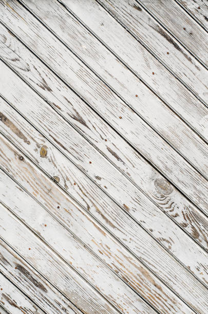 istock Old wooden gate is covered with shabby white paint. Texture. Oblique lines 670354038