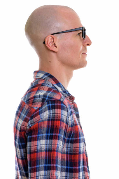 istock Profile view of young handsome bald man wearing eyeglasses 670354320