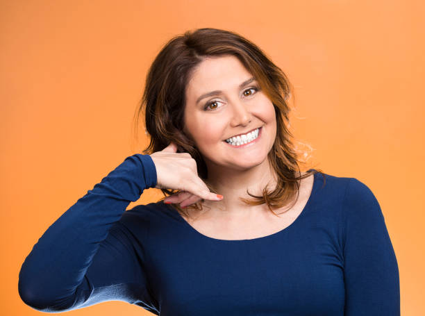 istock headshot young single woman making call me gesture, excited happy student, worker, 670357826