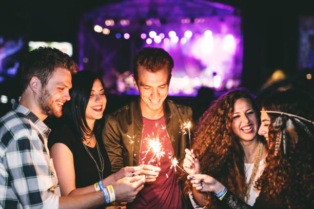istock Spraklers glowing, smile on their faces, favorite band playing, let's get this party started 670358230