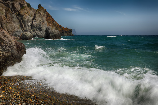 Rocky seashore and waves on a sunny day. Beautiful seascape.Nature composition.
