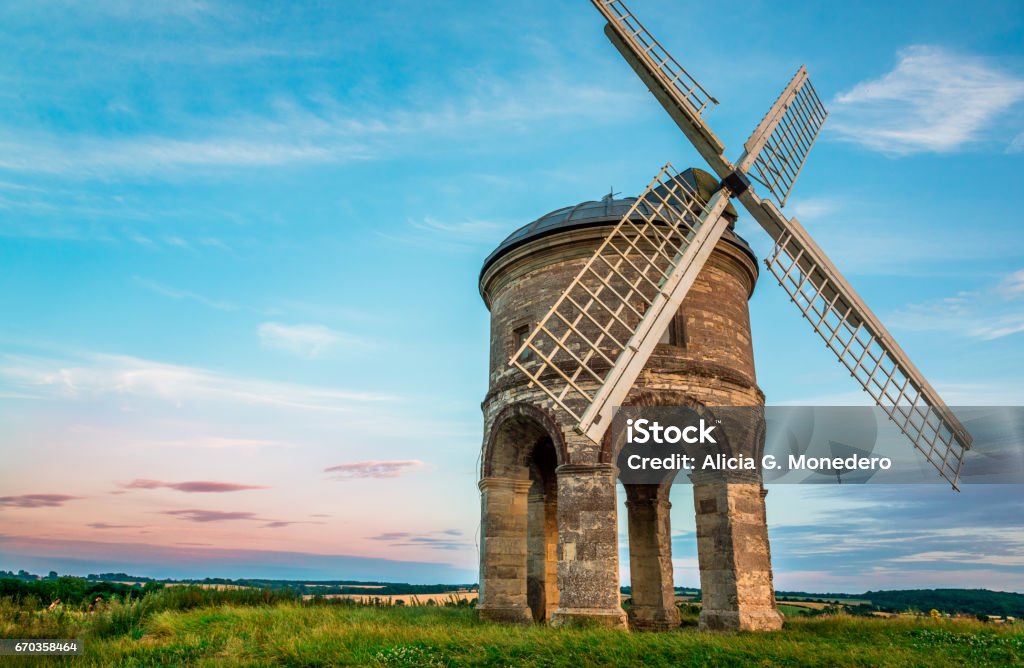 Windmill under a sweet sunset sky - UK Chesterton Windmill, a 17th-century cylindrical stone tower mill with an arched base, under a sweet sunset sky, in Warwickshire, West Midlands, UK. Leamington Spa Stock Photo