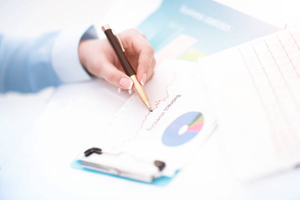 istock Image of business documents on workplace with partners interacting 670359044