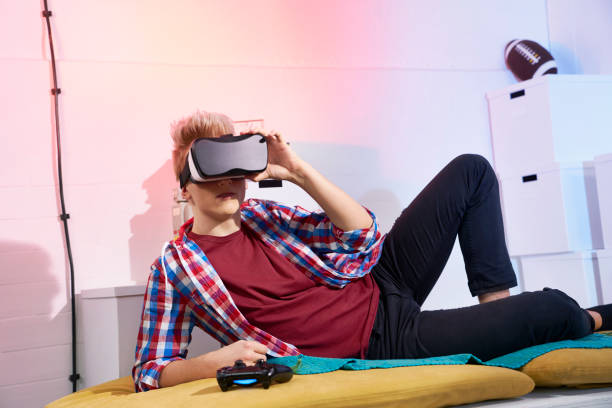 istock Teenager exploring virtual reality. Focused on simulated world 670359580