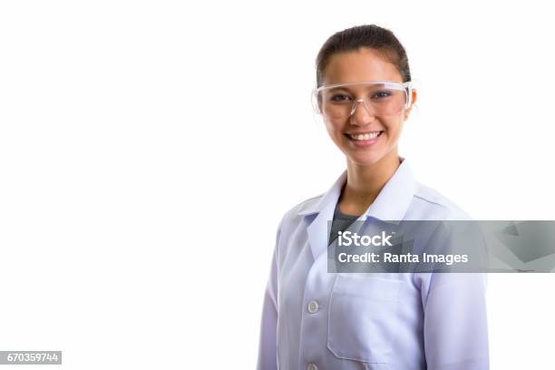 Studio Shot Of Young Happy Woman Doctor Smiling While Wearing Protective Glasses Stock Photo - Download Image Now