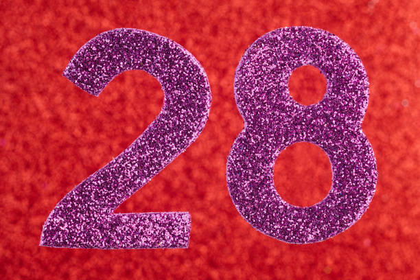 istock Number twenty-eight purple color over a red background. Anniversary. 670366798